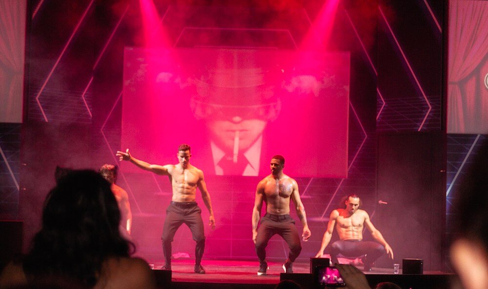 four men stripping on stage for female visitors 