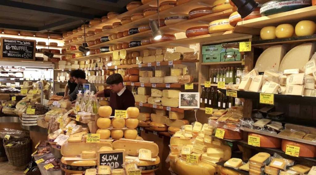 Dutch sandwich and cheese shop De Kaaskamer in Amsterdam with hundreds of cheeses and staff behind the counter