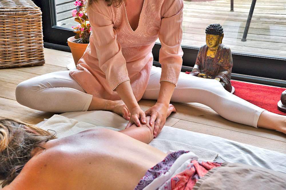 a woman giving an Asian massage to a customer.